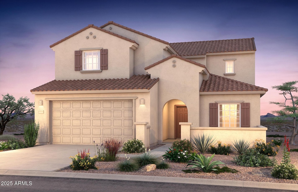 mediterranean / spanish-style house with a garage