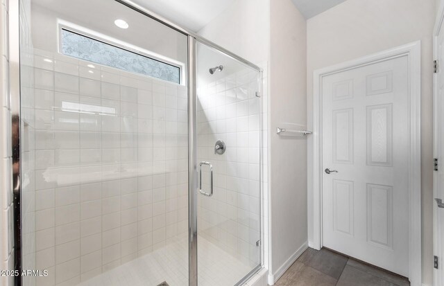 17857 W Getty Dr, Goodyear, AZ 85338 - bathroom with tile patterned flooring and a shower with door