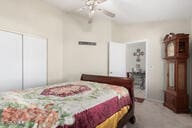 carpeted bedroom featuring ceiling fan