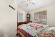 bedroom with ceiling fan and lofted ceiling