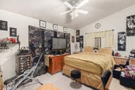 bedroom featuring vaulted ceiling and ceiling fan