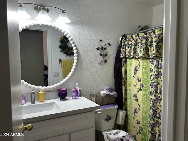 bathroom with vanity, a shower with shower curtain, and toilet