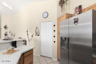 kitchen with light tile patterned flooring and stainless steel fridge with ice dispenser