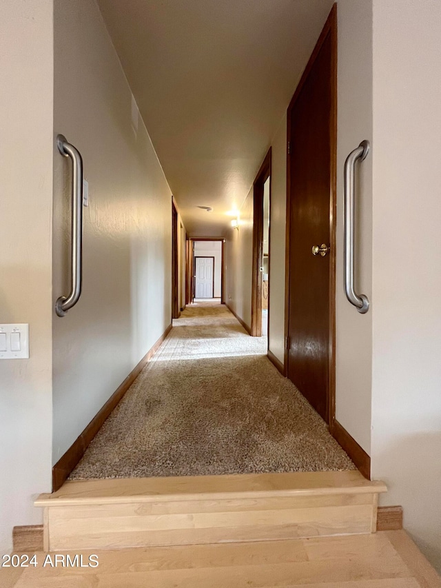 hall with light colored carpet