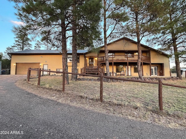 view of front of house featuring a deck and a garage