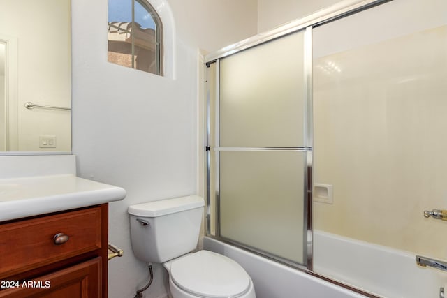 full bathroom featuring vanity, toilet, and bath / shower combo with glass door