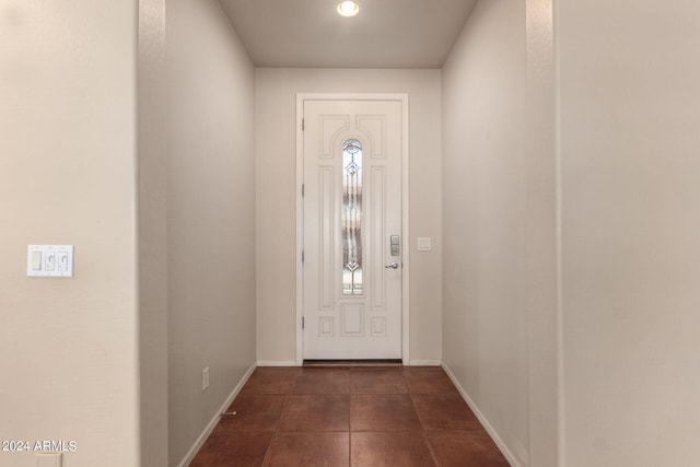 foyer entrance with dark tile patterned flooring