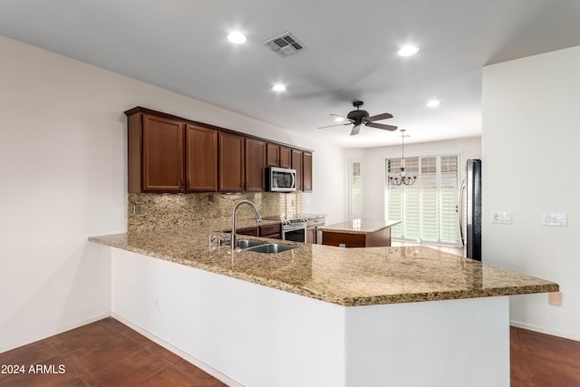 kitchen featuring a peninsula, visible vents, appliances with stainless steel finishes, and a sink