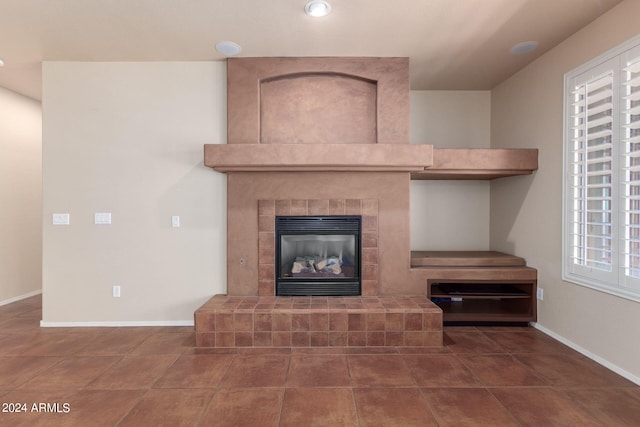 interior details with tile patterned flooring and a tile fireplace