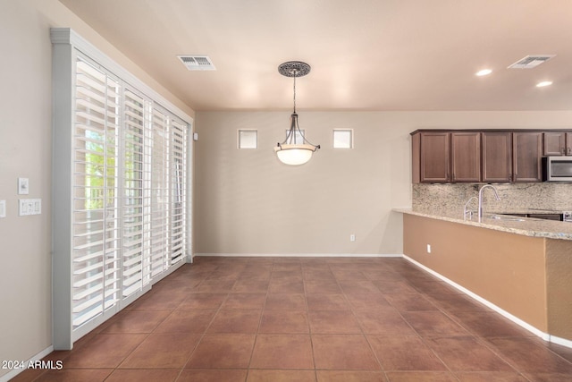 unfurnished dining area featuring sink and tile patterned floors