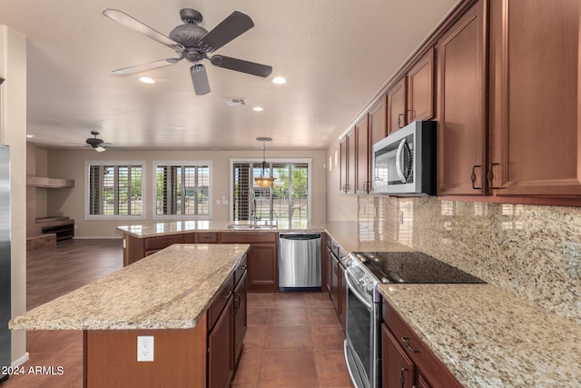 kitchen with kitchen peninsula, stainless steel appliances, plenty of natural light, and backsplash