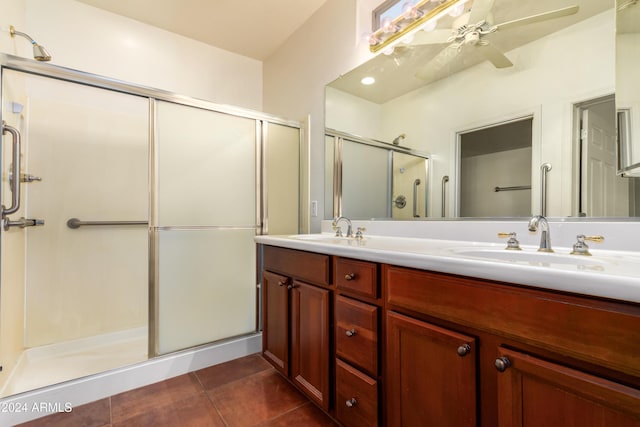 full bath with a stall shower, tile patterned flooring, a sink, and double vanity