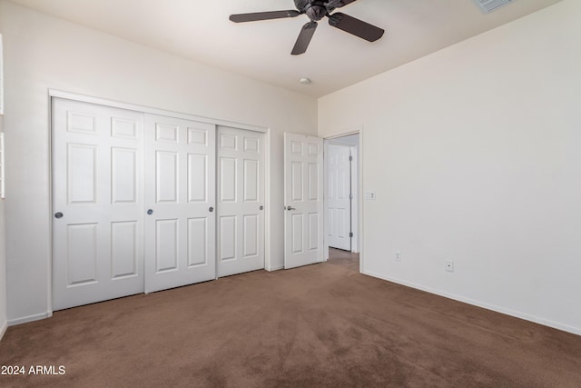 unfurnished bedroom with carpet floors, visible vents, baseboards, and a closet