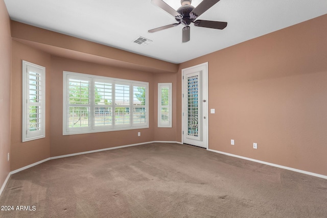 unfurnished room with ceiling fan and carpet