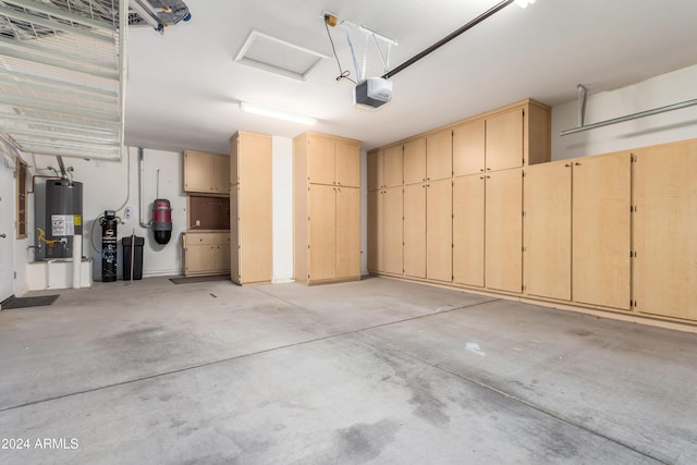 garage featuring gas water heater and a garage door opener