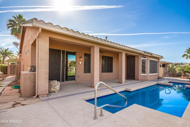 view of pool with a patio area and fence