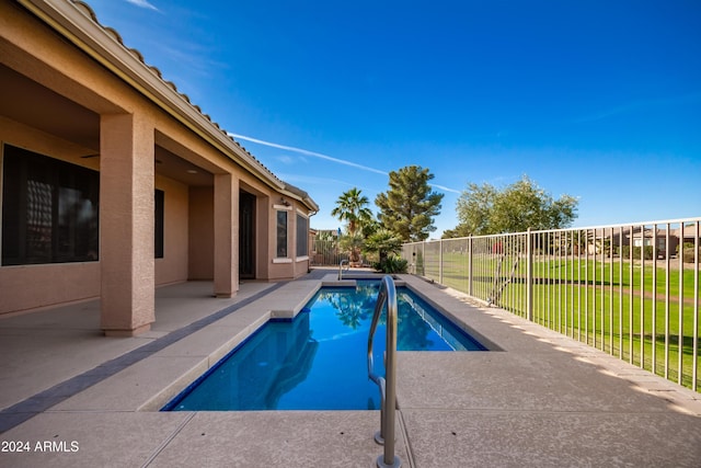 view of swimming pool featuring a lawn, a patio area, a fenced backyard, and a fenced in pool