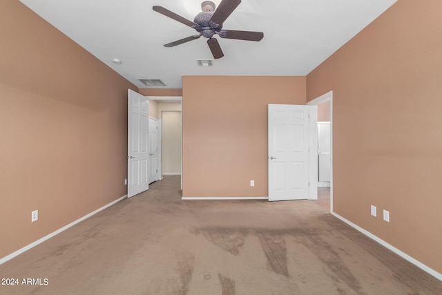 unfurnished bedroom featuring light colored carpet and ceiling fan