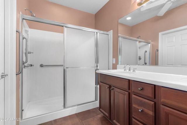 bathroom featuring ceiling fan, tile patterned flooring, walk in shower, and vanity