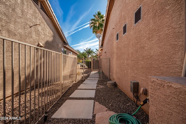 view of home's exterior featuring a gate, fence, and stucco siding