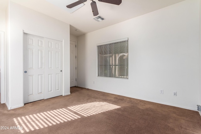 unfurnished bedroom featuring baseboards, visible vents, ceiling fan, carpet flooring, and a closet