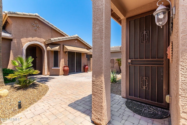 property entrance with a patio