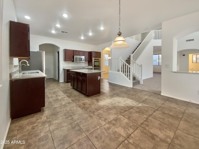 1274 W Dexter Way, San Tan Valley, AZ 85143 - kitchen with a sink, visible vents, stainless steel appliances, a kitchen island, and arched walkways