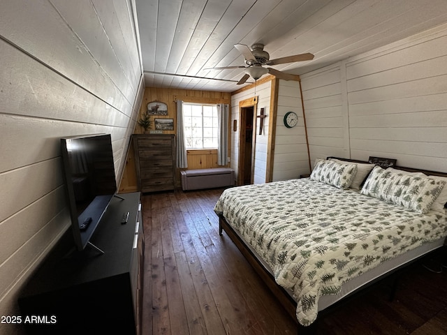 bedroom featuring wood ceiling, wood walls, and dark wood finished floors