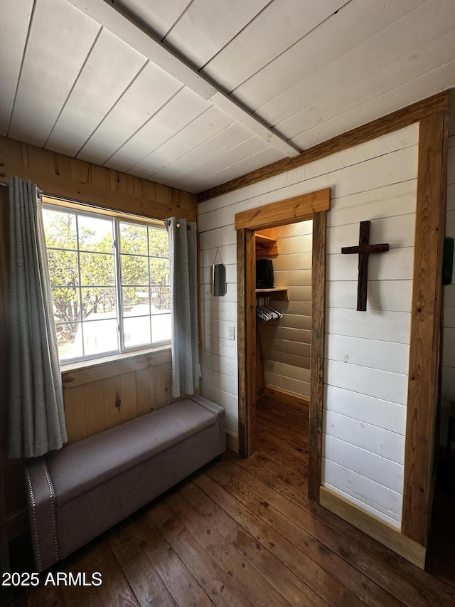 hallway with wooden walls and hardwood / wood-style flooring