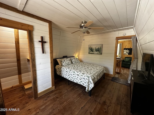 bedroom with dark wood-style flooring, wooden ceiling, and wooden walls