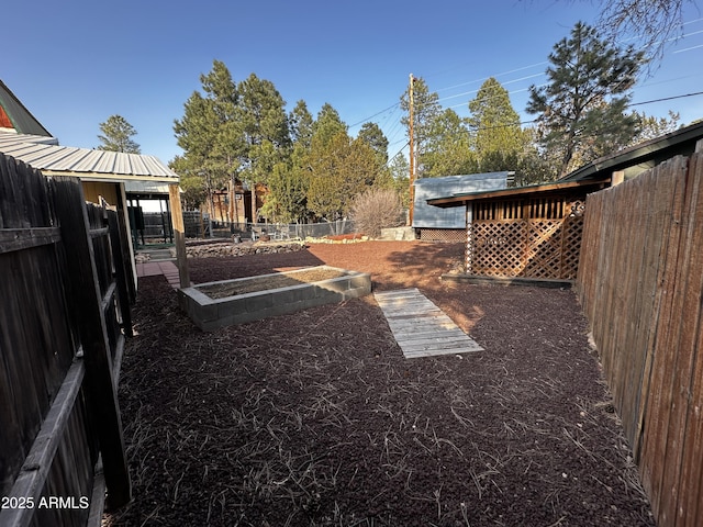 view of yard with a vegetable garden and fence private yard
