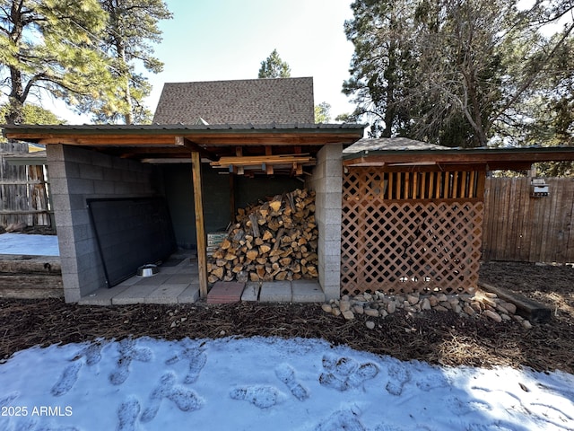 exterior space with fence and concrete block siding