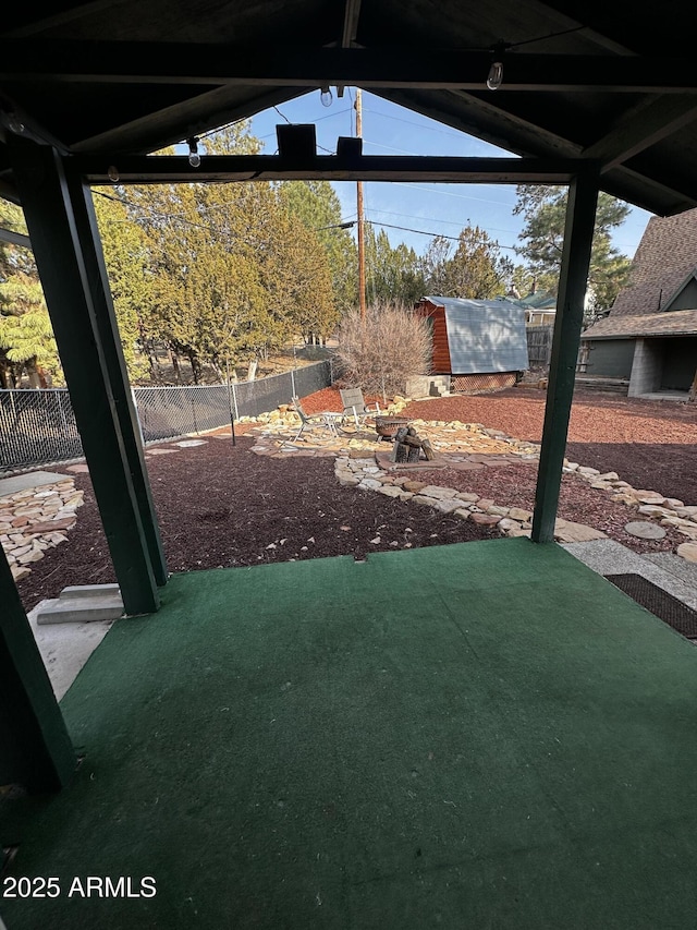 view of yard featuring a fenced backyard, a shed, and an outdoor structure