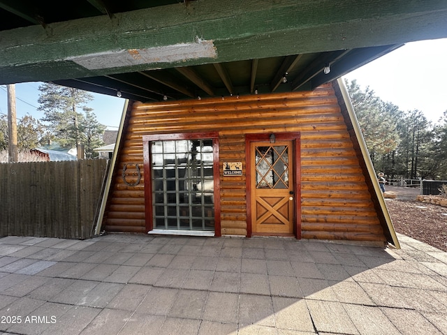 doorway to property with fence