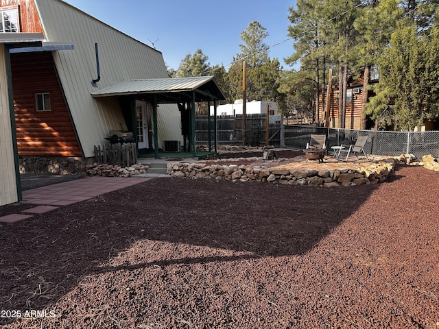 view of yard with an outdoor fire pit, fence, and a patio area