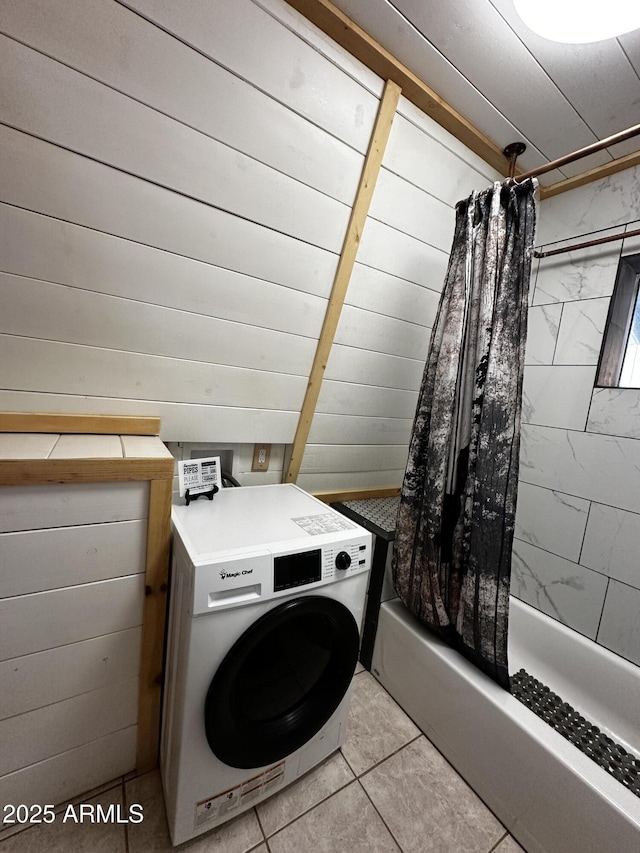 laundry area with wood walls, laundry area, and washer / dryer
