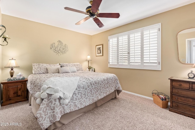 bedroom featuring light carpet, baseboards, and a ceiling fan