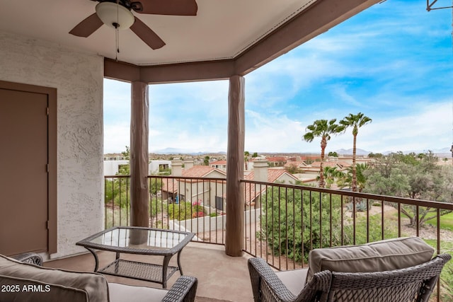 balcony with a residential view and a ceiling fan