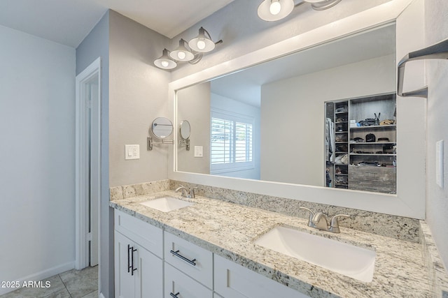 full bathroom with tile patterned flooring, double vanity, and a sink