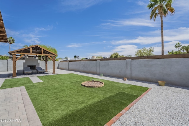 view of yard featuring a gazebo, a fenced backyard, and a patio area