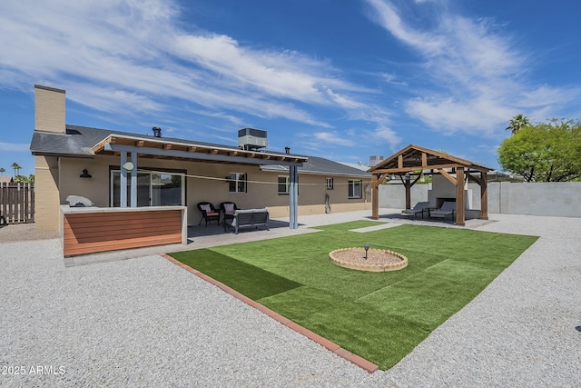 back of house with a patio, an outdoor hangout area, a gazebo, a lawn, and fence