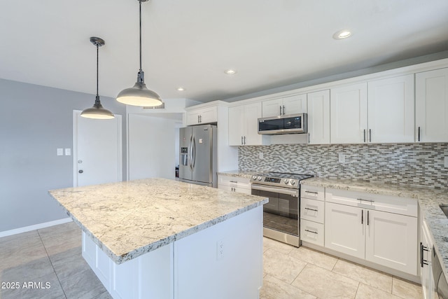 kitchen with decorative backsplash, stainless steel appliances, white cabinetry, a center island, and pendant lighting