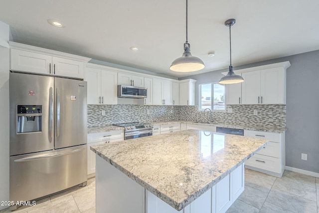 kitchen with white cabinetry, stainless steel appliances, decorative backsplash, and a sink