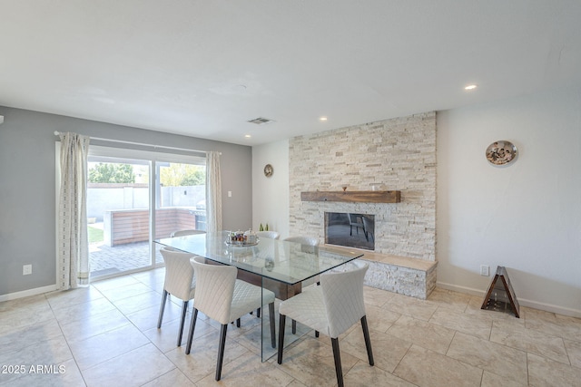 dining area with baseboards, visible vents, a fireplace, and recessed lighting