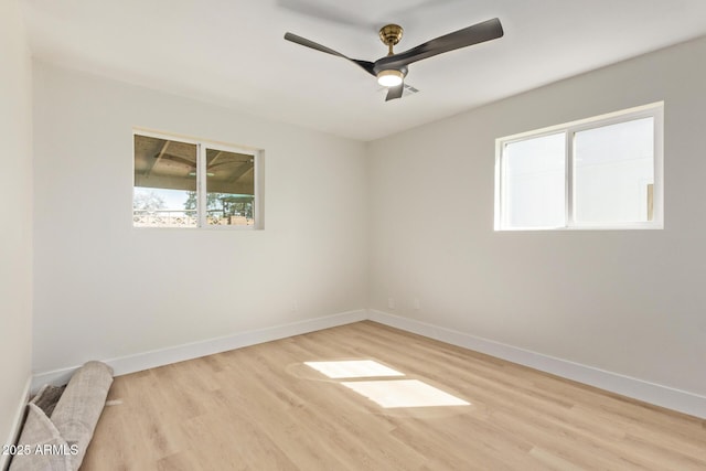 unfurnished room featuring baseboards, ceiling fan, and light wood finished floors