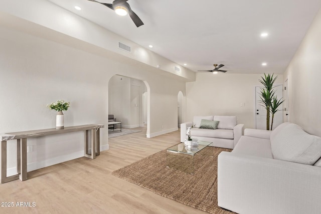 living room featuring visible vents, recessed lighting, arched walkways, ceiling fan, and light wood-style floors