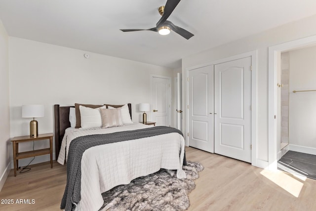 bedroom featuring light wood-type flooring, baseboards, a closet, and ceiling fan