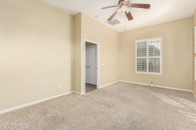 carpeted empty room with baseboards, visible vents, and ceiling fan