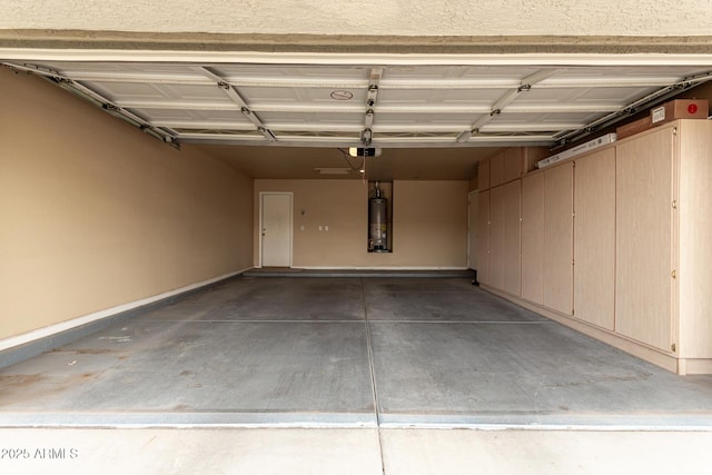 garage with baseboards, gas water heater, and a garage door opener