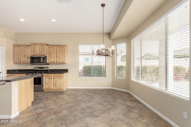 kitchen featuring a chandelier, light brown cabinets, stainless steel appliances, baseboards, and pendant lighting